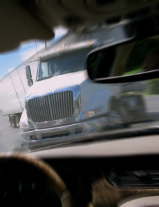 Close call crash avoidance with tractor trailer truck viewed from inside a car avoiding an imminent serious accident