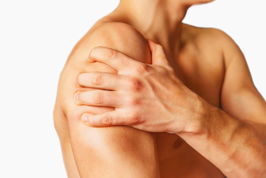 Man compresses his shoulder, pain in the shoulder. Shoulder close-up