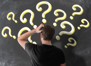 Puzzled Florida man with question marks around his head on chalkboard