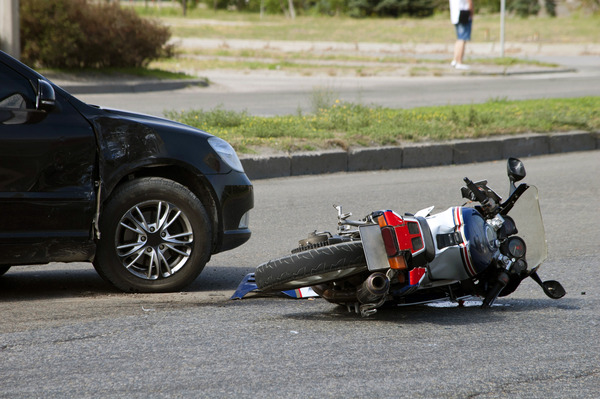 motorcycle knocked over after accident with car