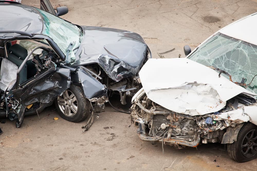 Two cars collided due to dangerous road conditions and heavy traffic.