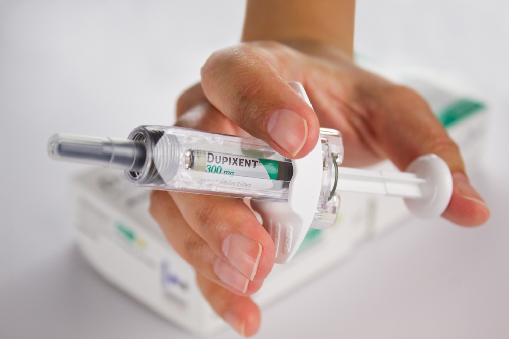 hand holding injection form of dupixent - Dupixent lawsuit - Dolman Law Group