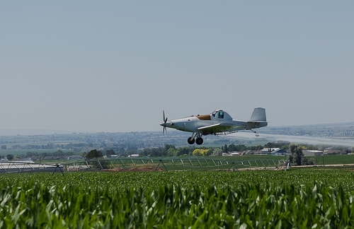 Chlorpyrifos being sprayed into a crop field with crop duster - Chlorpyrifos Lorsban Lawsuit - Dolman Law Group