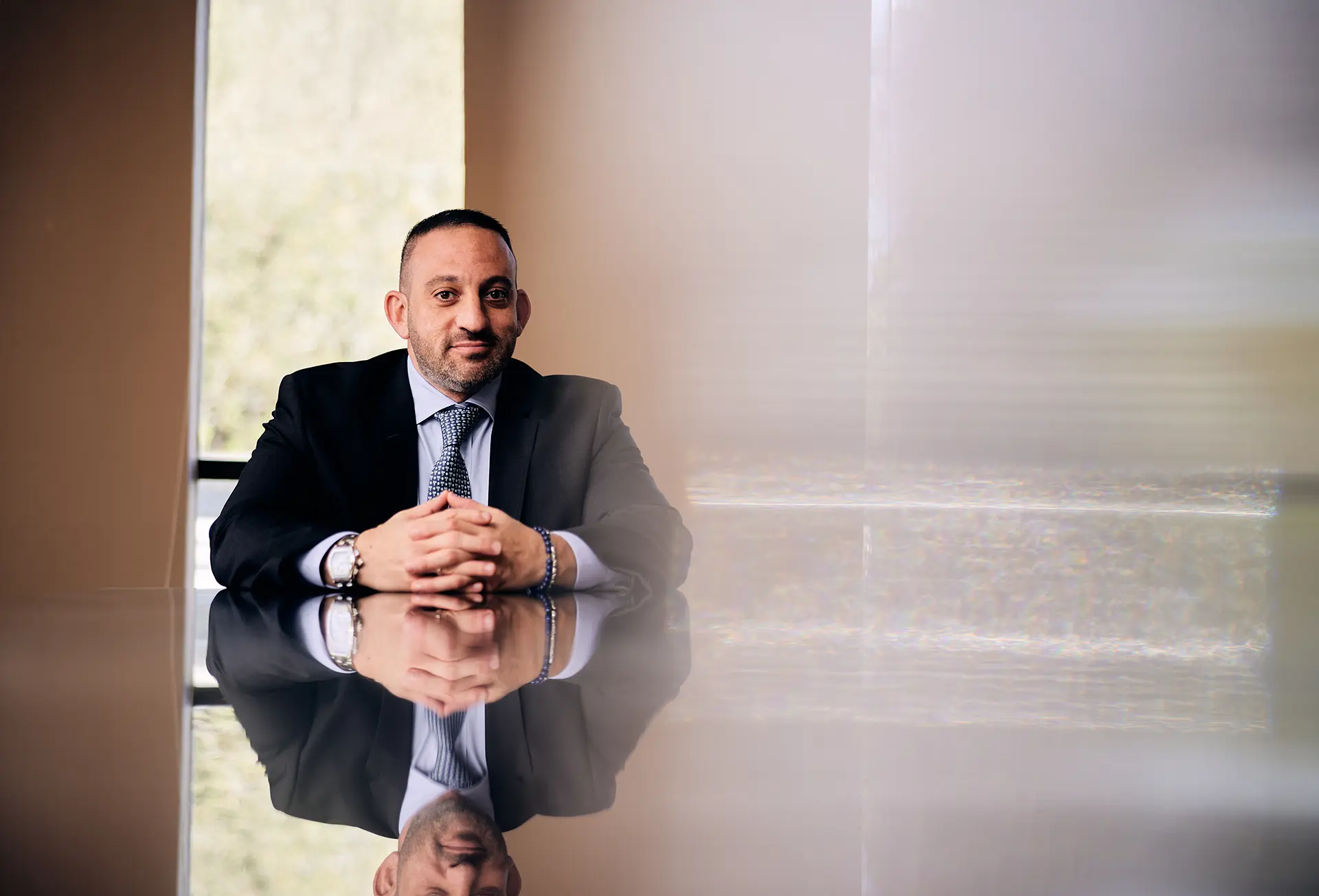 Matt Dolman at conference table that reflects his image