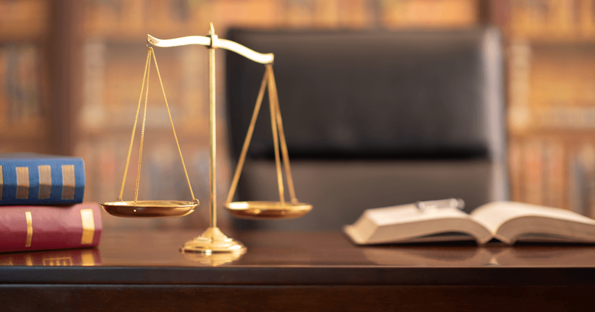 a judges desk - with books and the justice scales