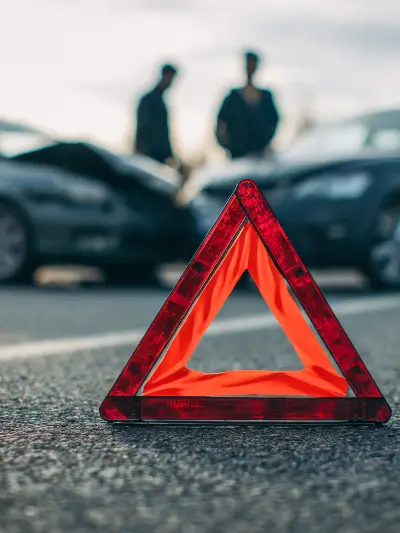 triangle road sign - car crash in background
