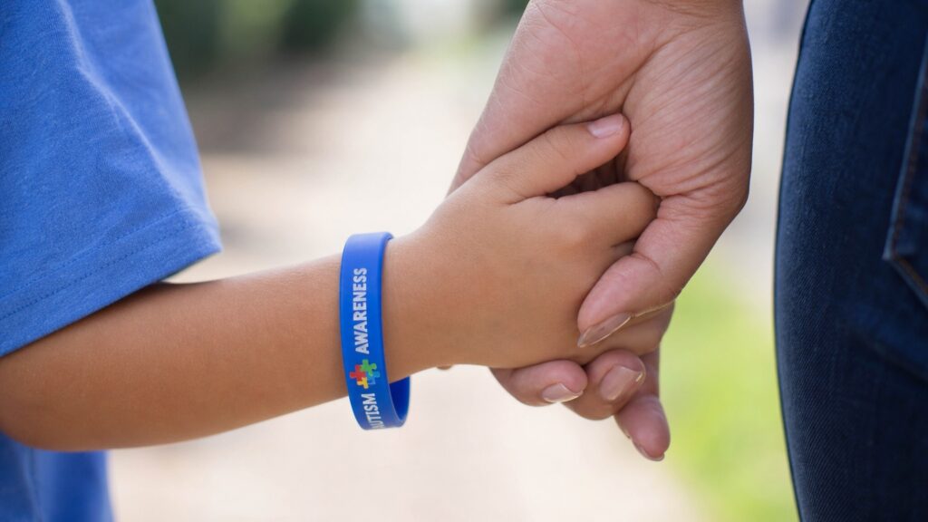 Child with autism bracelet holding his mom's hand - Tylenol Autism Lawsuit - Tylenol ADHD Lawsuit - Dolman Law Group