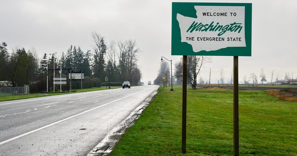 welcome to washington state road sign - Dolman Law Group